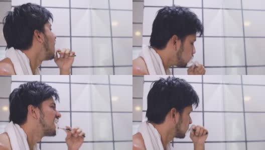 年轻的亚洲男人在浴室里刷牙侧视图高清在线视频素材下载