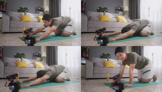 亚洲人健身教练教授或教练伸展下背部和手臂到他的在线学生在家锻炼。高清在线视频素材下载