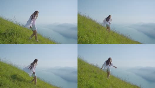 女孩走在草地上，看着加尔达湖美丽的全景高清在线视频素材下载