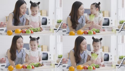 母亲和女儿在家里的厨房里做早餐健康的水果和蔬菜沙拉。周末活动快乐家庭生活理念。呆在家里。高清在线视频素材下载