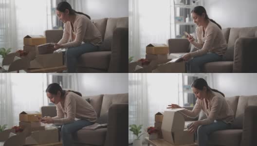 亚洲妇女消费者打开纸板箱领取邮包高清在线视频素材下载