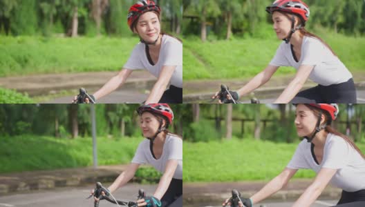 亚洲年轻美丽的女子在公园里为了健康骑自行车。感到愉悦放松和自由。高清在线视频素材下载