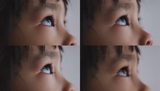 亚洲小孩仰望天空的特写。美丽的棕色眼睛，长长的睫毛。高清在线视频素材下载