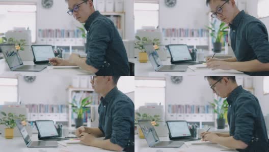 滑块拍摄的一个中年男子在他的家庭办公室处理他的个人财务高清在线视频素材下载