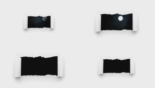 这是一段充满创意的4k时长的视频，视频中，夜空中一轮闪亮的满月和漂浮的云，通过一个白色纸上的边缘撕裂的洞可以看到。高清在线视频素材下载