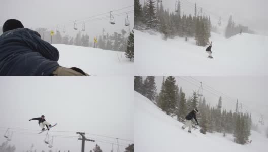 一个摄影师的慢动作拍摄的照片在完整的冬季装备滑雪板完成一个“西瓜抓取”的技巧在一个跳跃与森林和滑雪缆车在背景在博尔德附近的埃尔多拉滑雪度假村，科罗拉多州在一个下雪的，阴天高清在线视频素材下载