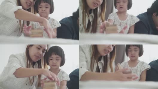 亚洲家庭，孩子在卧室玩木制玩具高清在线视频素材下载