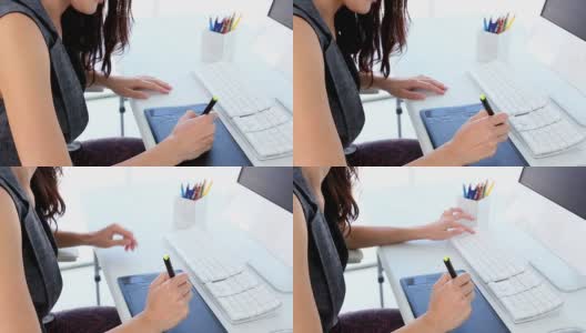 平面设计师在她的办公桌上用数字化仪工作高清在线视频素材下载