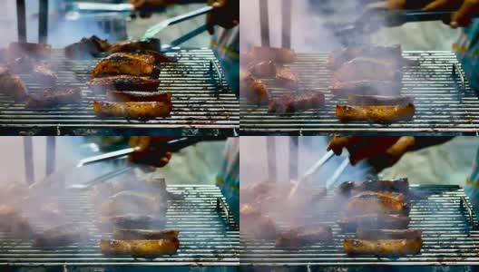 厨师的手是烧烤泰国风格的烧烤木炭和烟在泰国街头食品或夜市，美食和旅游的概念。高清在线视频素材下载