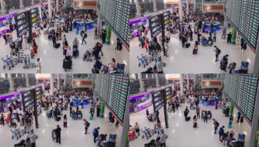 在机场航站楼，拥挤的乘客带着行李站在登机板前的4K时间间隔。晚上一群人在机场候机楼里散步高清在线视频素材下载