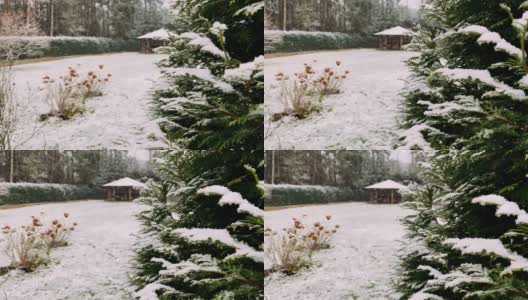 冬天的第一场雪，树枝上已经布满了雪。白雪覆盖的田野和巨大的木制凉亭。高清在线视频素材下载