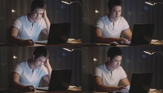 亚洲男性坐在笔记本前工作，晚上在家工作压力很大。高清在线视频素材下载