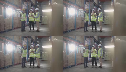 亚洲华人管理人员与仓库工人进行严肃的讨论与白帽使用数字平板电脑高清在线视频素材下载