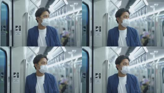 亚洲男子在地铁上戴口罩。高清在线视频素材下载