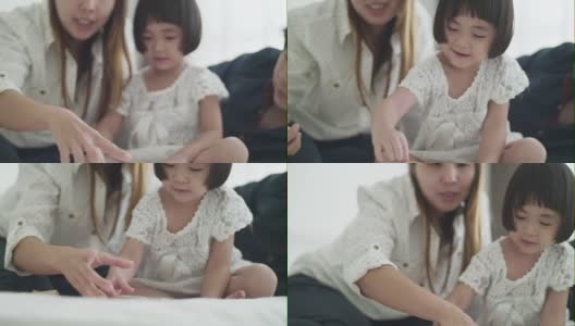 亚洲家庭，孩子在卧室玩木制玩具高清在线视频素材下载