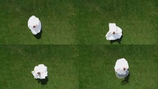 新娘和新郎在公园的无人机中盘旋。视图上高清在线视频素材下载