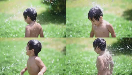 SLO MO蹒跚学步的孩子在家里的前院玩水。高清在线视频素材下载