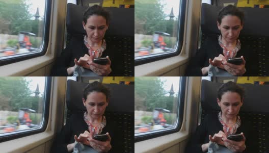 一名女子在通勤火车上查看手机。一名女子在偷看手机的照片高清在线视频素材下载