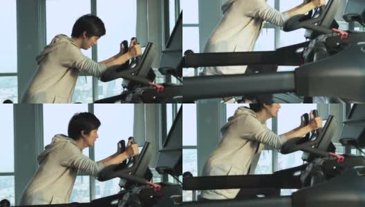 亚洲成年女运动员在健身房里做机器举重运动高清在线视频素材下载