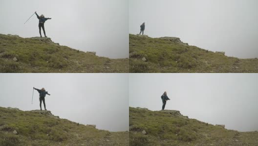 自由和幸福的观念与登山者快乐的女人登上山顶，举起手臂高清在线视频素材下载