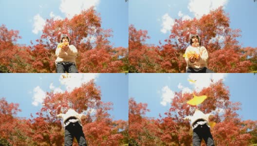 一个日本女孩在玩秋天的树叶高清在线视频素材下载