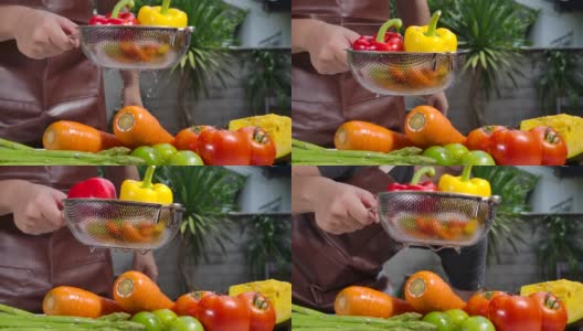 他正在洗水果和蔬菜。高清在线视频素材下载