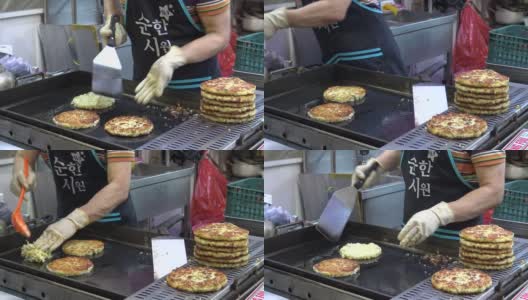 4K Bindaetteok, fried buchimgae, pancake in Gukje International Market Busan高清在线视频素材下载