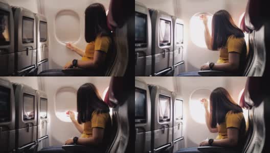 女乘客打开机舱窗户，慢动作高清在线视频素材下载