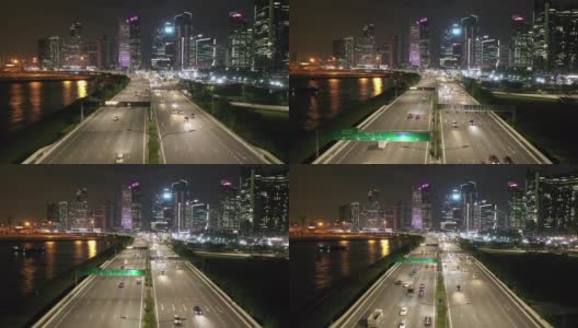 在新加坡，无人机在夜间拍摄高速公路上的交通和城市天际线高清在线视频素材下载
