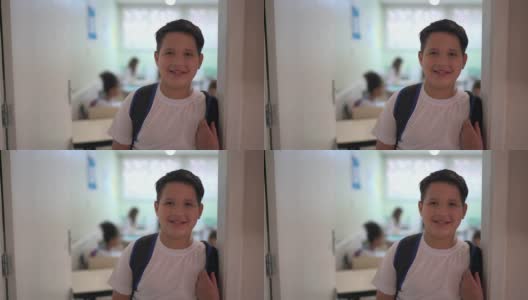 一个小学生站在教室门口的肖像高清在线视频素材下载