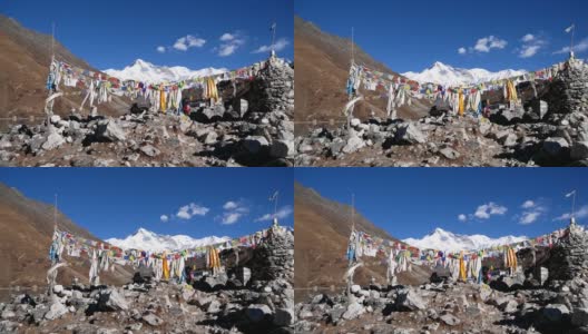 在尼泊尔的喜马拉雅山脉中，有雄伟的雪山卓奥友山，在Gokyo第三湖的岸边，一堆五颜六色的佛教经幡随风飘扬。高清在线视频素材下载