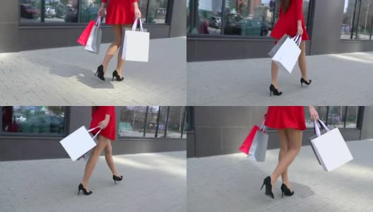 销售，消费主义:自信的女士高跟鞋和购物袋走在城市。漂亮的女腿高清在线视频素材下载