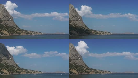 云层从岩石中出来，沿着高耸的悬崖环绕的美丽的海湾移动。旅行时欣赏自然美景(黑海、克里米亚、苏达克-里曼湾)高清在线视频素材下载