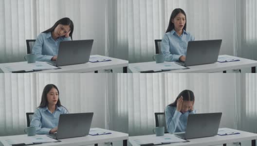 一名亚洲妇女在工作时引起头痛，所以她用手轻轻揉了揉她的头。高清在线视频素材下载