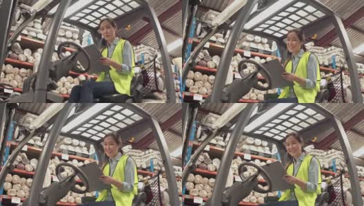 亚洲女工在仓库铲车上的肖像高清在线视频素材下载