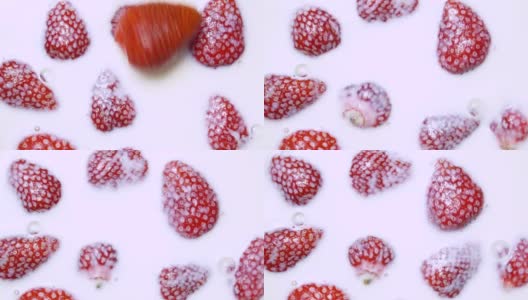 红熟草莓落入牛奶的慢动作视频捕捉高清在线视频素材下载