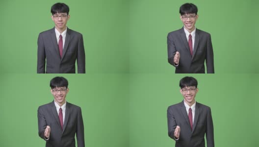 年轻快乐的亚洲商人微笑着握手高清在线视频素材下载