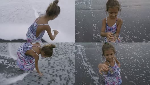 小女孩站在海水里和螃蟹玩高清在线视频素材下载