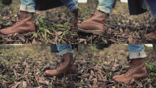走路的腿在棕色的鞋子侧视图。穿着棕色皮靴走路的脚高清在线视频素材下载