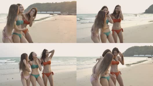 一组三个亚洲妇女在比基尼享受一个放松的夏天在热带海滩。缓慢的运动。庆祝和放松的概念。高清在线视频素材下载