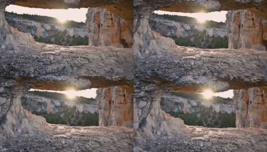 在西班牙索里亚的狼河峡谷，阳光透过一个风景优美的岩石形成的洞。高质量4k镜头高清在线视频素材下载