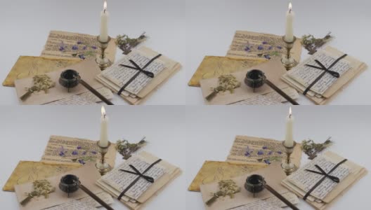 燃着的蜡烛和古老的信件。记忆,家庭档案高清在线视频素材下载