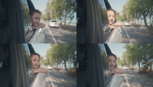 快乐的亚洲小女孩享受和父母在海滩公路旅行假期的车里玩得开心。高清在线视频素材下载