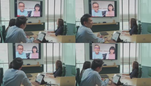 亚洲白领与公司员工进行视频会议会议讨论在会议室董事会与外国投资者进行视频会议。公司并购业务会议高清在线视频素材下载