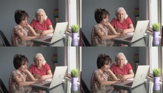 老奶奶和孙子在家里使用笔记本电脑高清在线视频素材下载