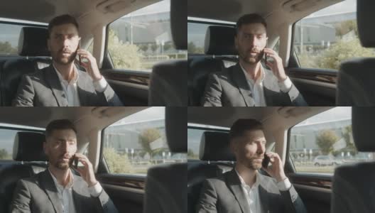 一位自信的商人在商务舱旅行时正在打电话。一个英俊的白人男性坐在他的豪华轿车里，和他自己的司机一起。成功的生活方式高清在线视频素材下载