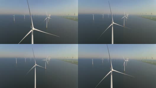 风力涡轮机在清晨，风车公园在荷兰。从空中看风力涡轮机，无人机在windpark westermeerdijk的一个风车农场在IJsselmeer湖最大的荷兰高清在线视频素材下载