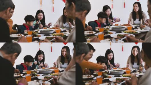 中国农历新年，欢乐的亚洲一家三口欢聚一堂，共进年夜饭高清在线视频素材下载