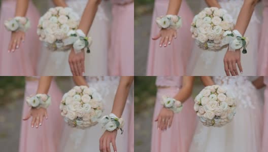 穿着粉色礼服的新娘和伴娘捧着花束。高清在线视频素材下载
