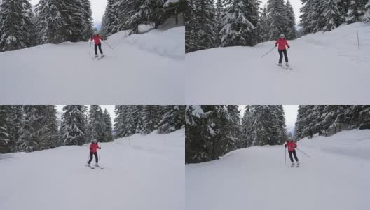 运动女子在高山滑雪胜地的一个斜坡上专业滑雪高清在线视频素材下载